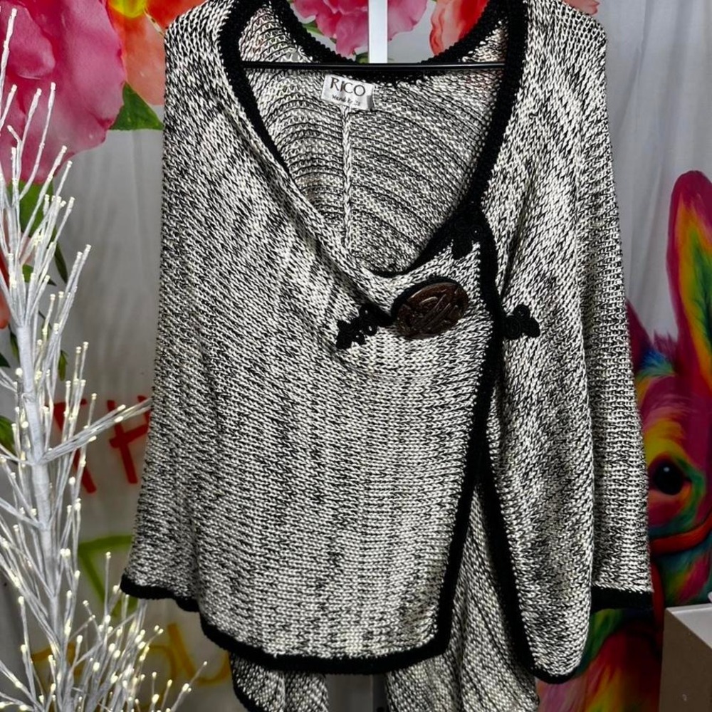 W153. Rico black & white crochet poncho with cool button detail